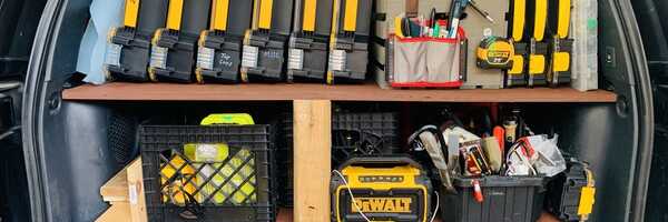 Hand tools, clamps, cases, and supplies organized in a work van
